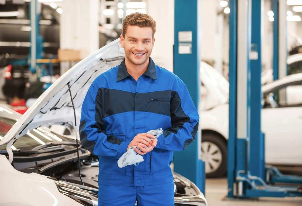Automotive technician in a repair workshop — illustrative photograph