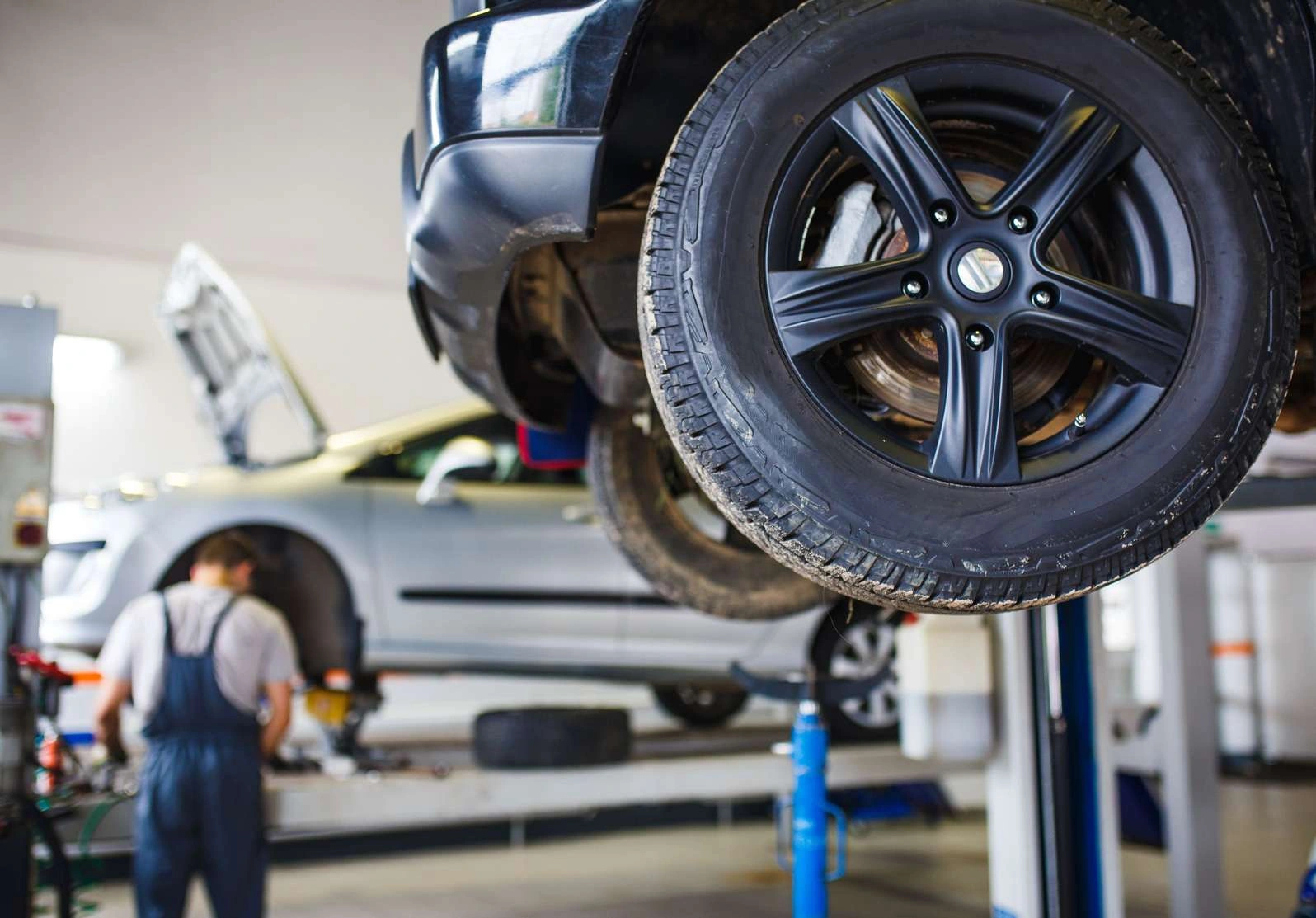 Vehicle on a lift in a professional automotive workshop — illustrative photograph